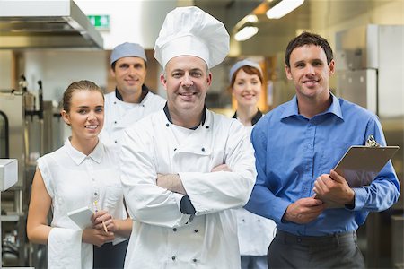 simsearch:400-07140055,k - Head chef posing with the team behind him in a profesional kitchen Stock Photo - Budget Royalty-Free & Subscription, Code: 400-07140035