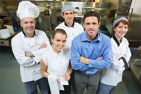 simsearch:400-07140055,k - Handsome manager posing with some chefs and waitress in a kitchen Stock Photo - Budget Royalty-Free & Subscription, Code: 400-07140031