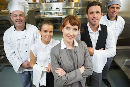 simsearch:400-07140055,k - Cute female manager posing with the staff in a modern kitchen Stock Photo - Budget Royalty-Free & Subscription, Code: 400-07140041