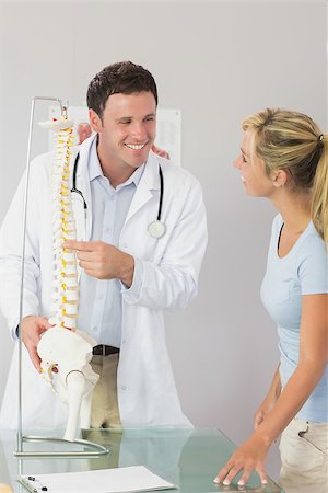 female pelvis - Cheerful doctor showing a patient something on skeleton model in bright office Stock Photo - Budget Royalty-Free & Subscription, Code: 400-07140128