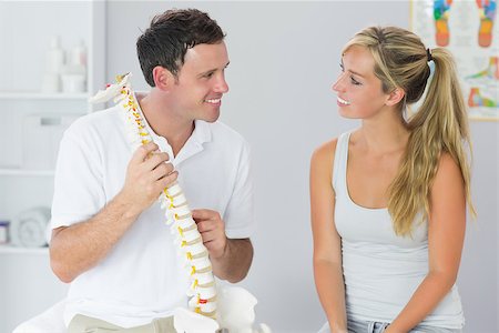 female pelvis - Smiling physiotherapist showing patient something on skeleton model in bright office Stock Photo - Budget Royalty-Free & Subscription, Code: 400-07140181