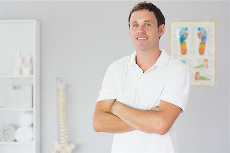 skeletons human not illustration not xray - Handsome happy physiotherapist standing with arms crossed in bright office Stock Photo - Budget Royalty-Free & Subscription, Code: 400-07140183