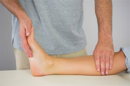 foot exam - Physiotherapist checking patients foot in bright office Stock Photo - Budget Royalty-Free & Subscription, Code: 400-07140250