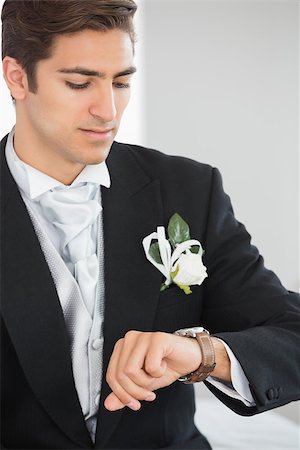 simsearch:400-04171391,k - Handsome bridegroom watching the clock wearing a suit Stock Photo - Budget Royalty-Free & Subscription, Code: 400-07140320