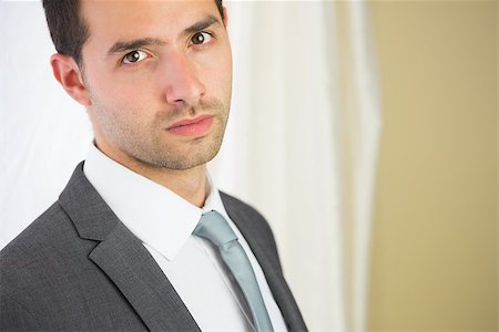 simsearch:400-07275251,k - Handsome unsmiling businessman looking at camera in bright room Stock Photo - Budget Royalty-Free & Subscription, Code: 400-07141011