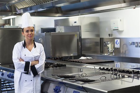 fornellino elettrico - Young happy chef standing next to work surface arms crossed in professional kitchen Fotografie stock - Microstock e Abbonamento, Codice: 400-07141097