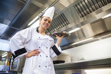 Young smiling chef holding tray in professional kitchen Stock Photo - Budget Royalty-Free & Subscription, Code: 400-07141108