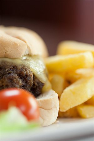 simsearch:614-06813733,k - Close up of cheesy burger with french fries on white plate Stock Photo - Budget Royalty-Free & Subscription, Code: 400-07141204