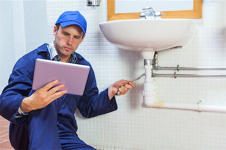 simsearch:400-07929361,k - Serious plumber consulting tablet in public bathroom Stockbilder - Microstock & Abonnement, Bildnummer: 400-07141271