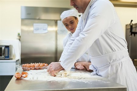 pastry chef uniform for women - Serious head chef kneading dough in professional kitchen Stock Photo - Budget Royalty-Free & Subscription, Code: 400-07141308