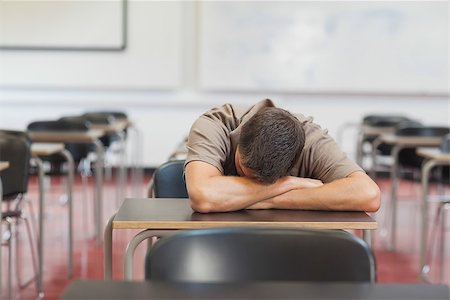 sleeping in a classroom - Male mature student lying his head on the desk while sleeping in the classroom Stock Photo - Budget Royalty-Free & Subscription, Code: 400-07141706