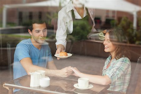 A couple holding hands while waitress serving food in college canteen Stock Photo - Budget Royalty-Free & Subscription, Code: 400-07141856