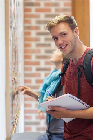 school bag pen - Cheerful student searching something on notice board in school Stock Photo - Budget Royalty-Free & Subscription, Code: 400-07141865