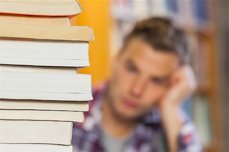 simsearch:400-07141917,k - Student studying between piles of books in library Stock Photo - Budget Royalty-Free & Subscription, Code: 400-07141929