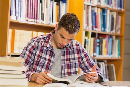 simsearch:400-07141917,k - Handsome calm student studying his books in library Stock Photo - Budget Royalty-Free & Subscription, Code: 400-07141935