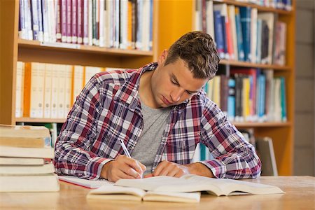 simsearch:6109-07497514,k - Handsome concentrated student studying his books in library Stockbilder - Microstock & Abonnement, Bildnummer: 400-07141936
