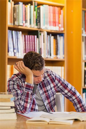 simsearch:6109-07497514,k - Handsome tired student studying his books in library Stockbilder - Microstock & Abonnement, Bildnummer: 400-07141939