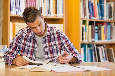 simsearch:400-07141917,k - Handsome focused student studying his books in library Stock Photo - Budget Royalty-Free & Subscription, Code: 400-07141932