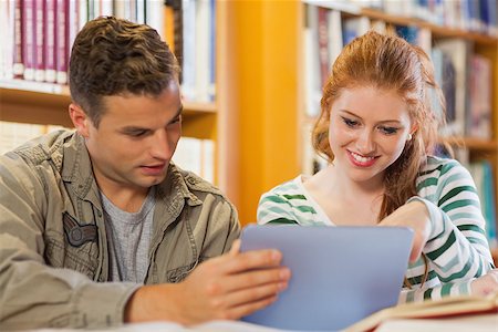 simsearch:6109-07497514,k - Two cheerful students studying together using tablet in library Stockbilder - Microstock & Abonnement, Bildnummer: 400-07141956