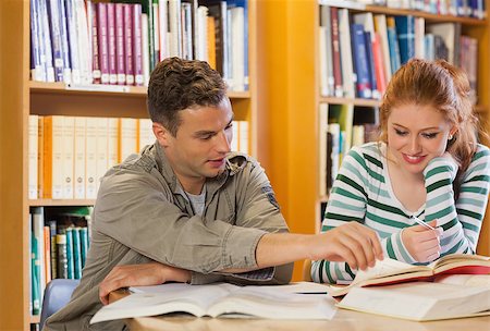 simsearch:400-07141917,k - Two smiling students studying together in library Stock Photo - Budget Royalty-Free & Subscription, Code: 400-07141953