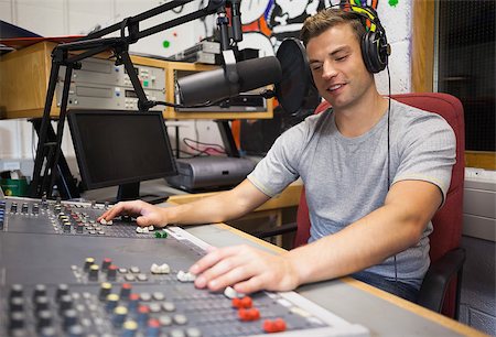 Handsome happy radio host moderating in studio at college Stock Photo - Budget Royalty-Free & Subscription, Code: 400-07142012