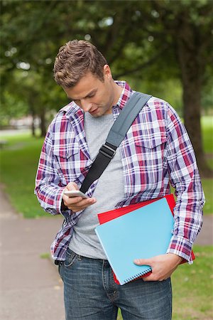 students campus phones - Handsome casual student standing and texting on campus at college Stock Photo - Budget Royalty-Free & Subscription, Code: 400-07142053
