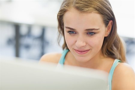 simsearch:400-07267978,k - Smiling pretty student working on computer in computer room at college Stock Photo - Budget Royalty-Free & Subscription, Code: 400-07142117