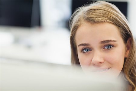 simsearch:400-07267978,k - Cheerful pretty student working on computer in computer room at college Stock Photo - Budget Royalty-Free & Subscription, Code: 400-07142120