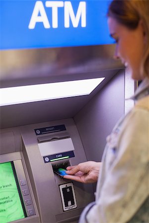 Pretty student withdrawing cash at an ATM Fotografie stock - Microstock e Abbonamento, Codice: 400-07142144