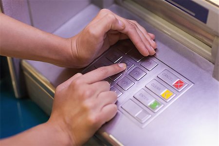 Close up of hand entering pin at an ATM Fotografie stock - Microstock e Abbonamento, Codice: 400-07142148