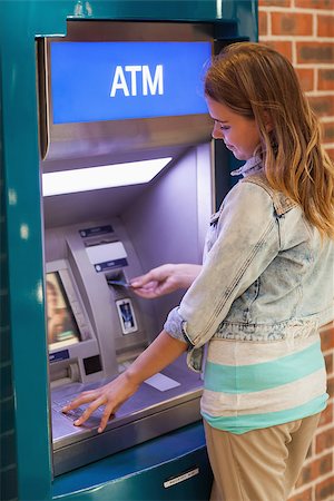 simsearch:400-07142149,k - Pretty happy student withdrawing cash at an ATM Stock Photo - Budget Royalty-Free & Subscription, Code: 400-07142143