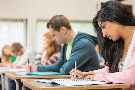 Side view of a group of young students writing notes in the classroom Stock Photo - Budget Royalty-Free & Subscription, Code: 400-07142422