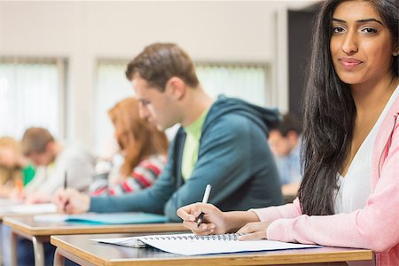 pictures of indian college classrooms in class room - Portrait of a young female student with others writing notes in the classroom Stock Photo - Budget Royalty-Free & Subscription, Code: 400-07142423