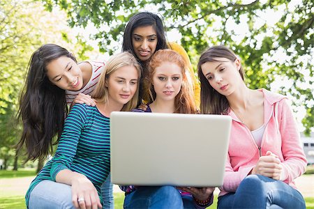 Group of young college girls using laptop in the park Stock Photo - Budget Royalty-Free & Subscription, Code: 400-07142626