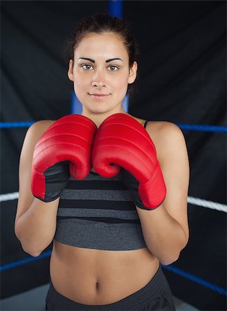 Portrait of a beautiful young woman in red boxing gloves in the ring Stock Photo - Budget Royalty-Free & Subscription, Code: 400-07143079