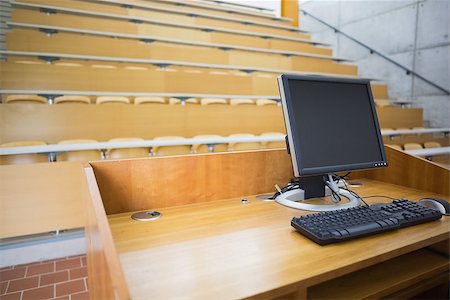 simsearch:700-02121517,k - View of computer monitor with empty wooden seats with tables in a lecture hall Stock Photo - Budget Royalty-Free & Subscription, Code: 400-07143297