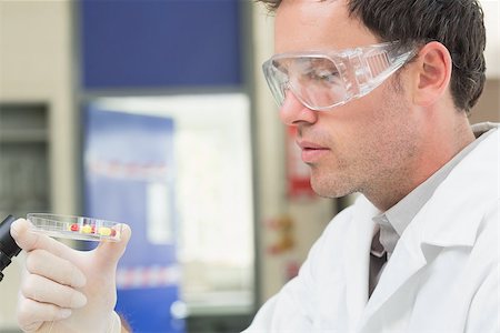 Close up side view of a male scientist analyzing pills in the laboratory Stock Photo - Budget Royalty-Free & Subscription, Code: 400-07143377