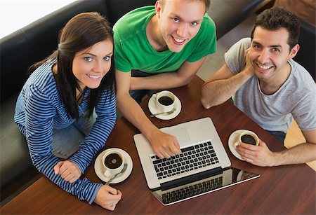 Overhead portrait of three students using laptop while having coffee at  the coffee shop Stock Photo - Budget Royalty-Free & Subscription, Code: 400-07143646