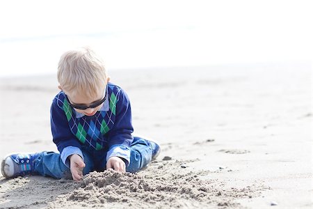 simsearch:400-04596901,k - cute caucasian toddler boy playing at the beach with sand in warm clothing Stock Photo - Budget Royalty-Free & Subscription, Code: 400-07165154