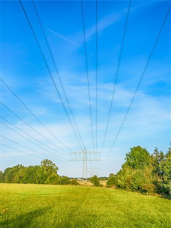 simsearch:400-07055373,k - Power cable and power pole on a green meadow under a blue sky with white clouds Fotografie stock - Microstock e Abbonamento, Codice: 400-07165263