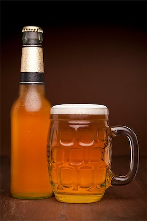 frothy head - A glass and a bottle of beer on a wooden table. Foto de stock - Super Valor sin royalties y Suscripción, Código: 400-07165342