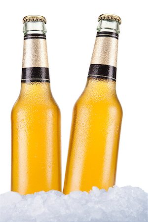 simsearch:400-07165360,k - Two beer bottles sitting on ice over a white background. Foto de stock - Royalty-Free Super Valor e Assinatura, Número: 400-07165359