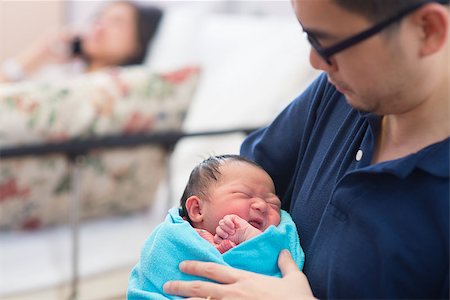 Newborn Asian baby girl crying in father's arms, inside hospital room Stock Photo - Budget Royalty-Free & Subscription, Code: 400-07165614