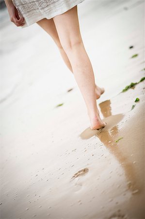 simsearch:400-04912125,k - Close up of a woman's legs walking along the beach as the tide comes in Stock Photo - Budget Royalty-Free & Subscription, Code: 400-07165944