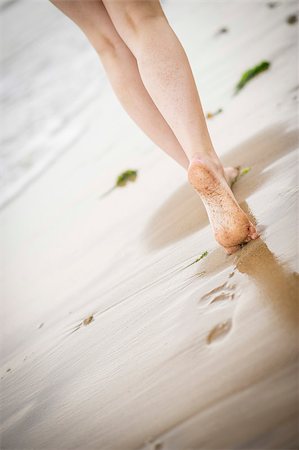 simsearch:400-04912125,k - Close up of a woman's legs walking along the beach as the tide comes in Stock Photo - Budget Royalty-Free & Subscription, Code: 400-07165946