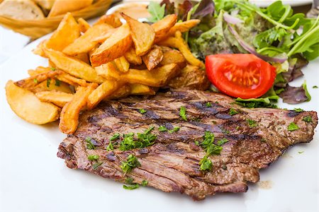 fast food salad - juicy steak beef meat with tomato and potatoes Stock Photo - Budget Royalty-Free & Subscription, Code: 400-07166187