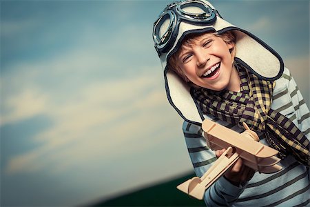simsearch:400-08613554,k - Laughing child with wooden plane Stock Photo - Budget Royalty-Free & Subscription, Code: 400-07166377