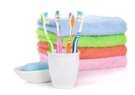 simsearch:400-04789848,k - Four colorful toothbrushes, soap and towels. Isolated on white background Stock Photo - Budget Royalty-Free & Subscription, Code: 400-07166564