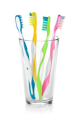 Colorful toothbrushes in glass. Isolated on white background Stock Photo - Budget Royalty-Free & Subscription, Code: 400-07166585