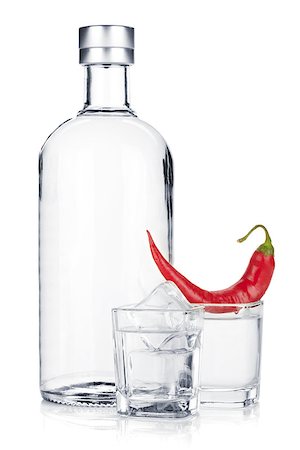 Bottle of vodka and shot glass with ice and red chili pepper. Isolated on white background Stock Photo - Budget Royalty-Free & Subscription, Code: 400-07166601